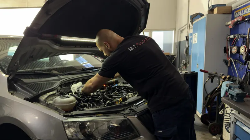 Servicearbeiten im Motorraum eines Pkw in der freien Kfz-Werkstatt Magarage