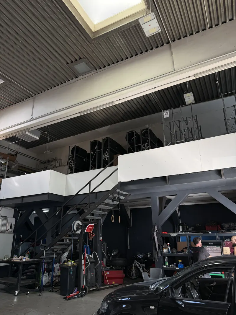 Blick in die Werkstatthalle der Magarage in Wien Liesing, oben die Galerie mit dem Reifenlager